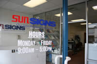 Sunsigns - door showing hours of operation Monday-Friday 9:00am-5:00pm